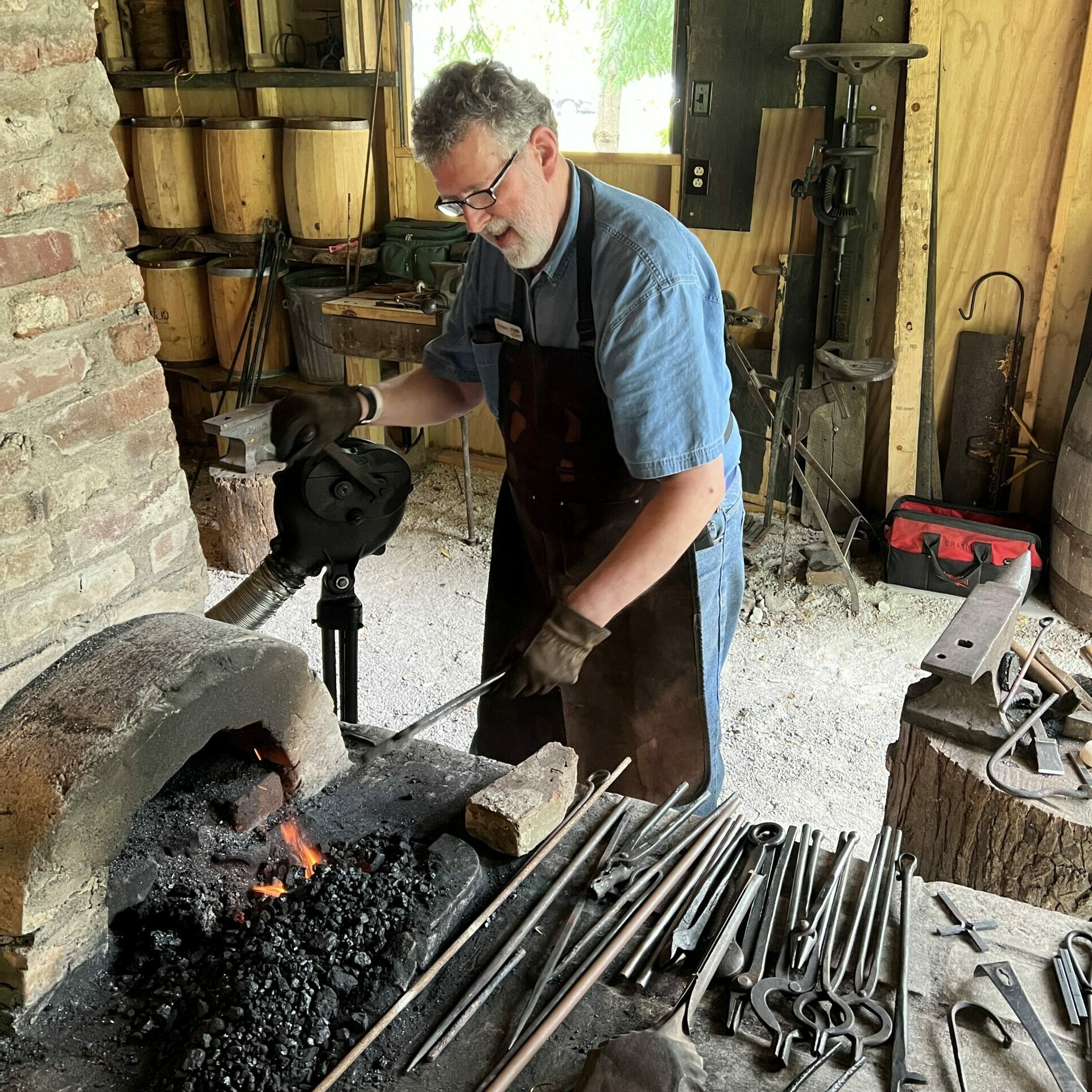 A blacksmith works at the forge