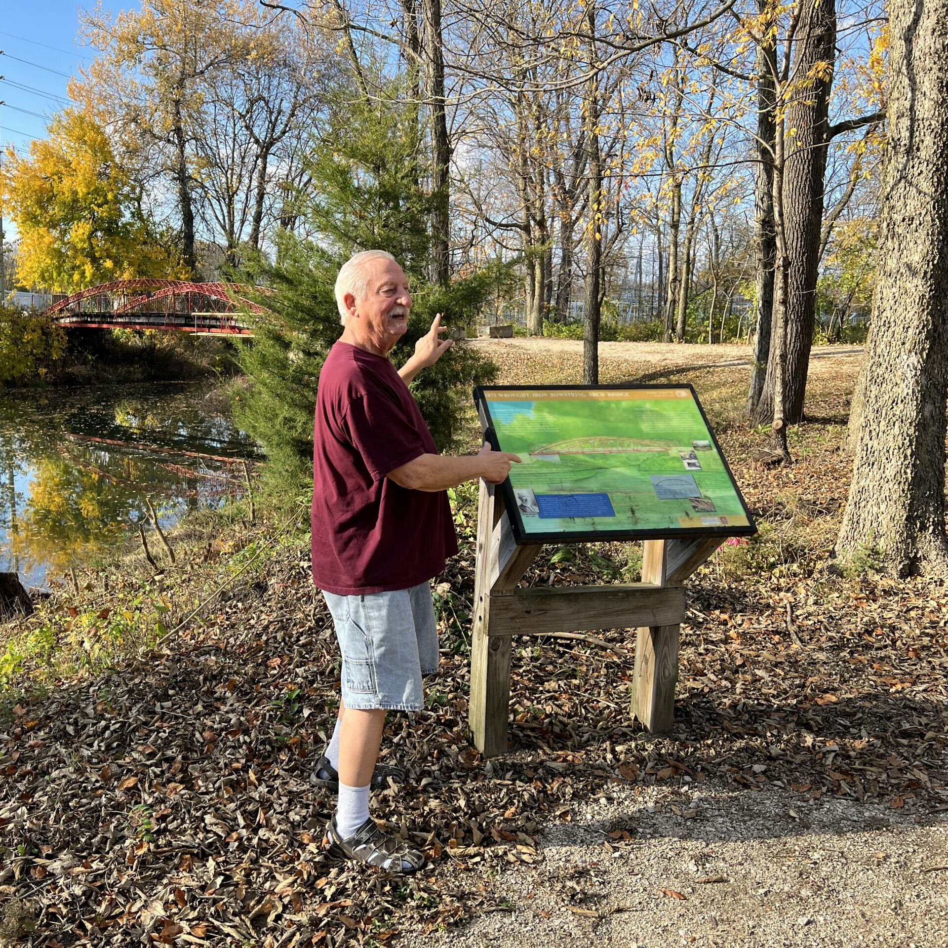A tour guide shares from an interpretive panel along the trails