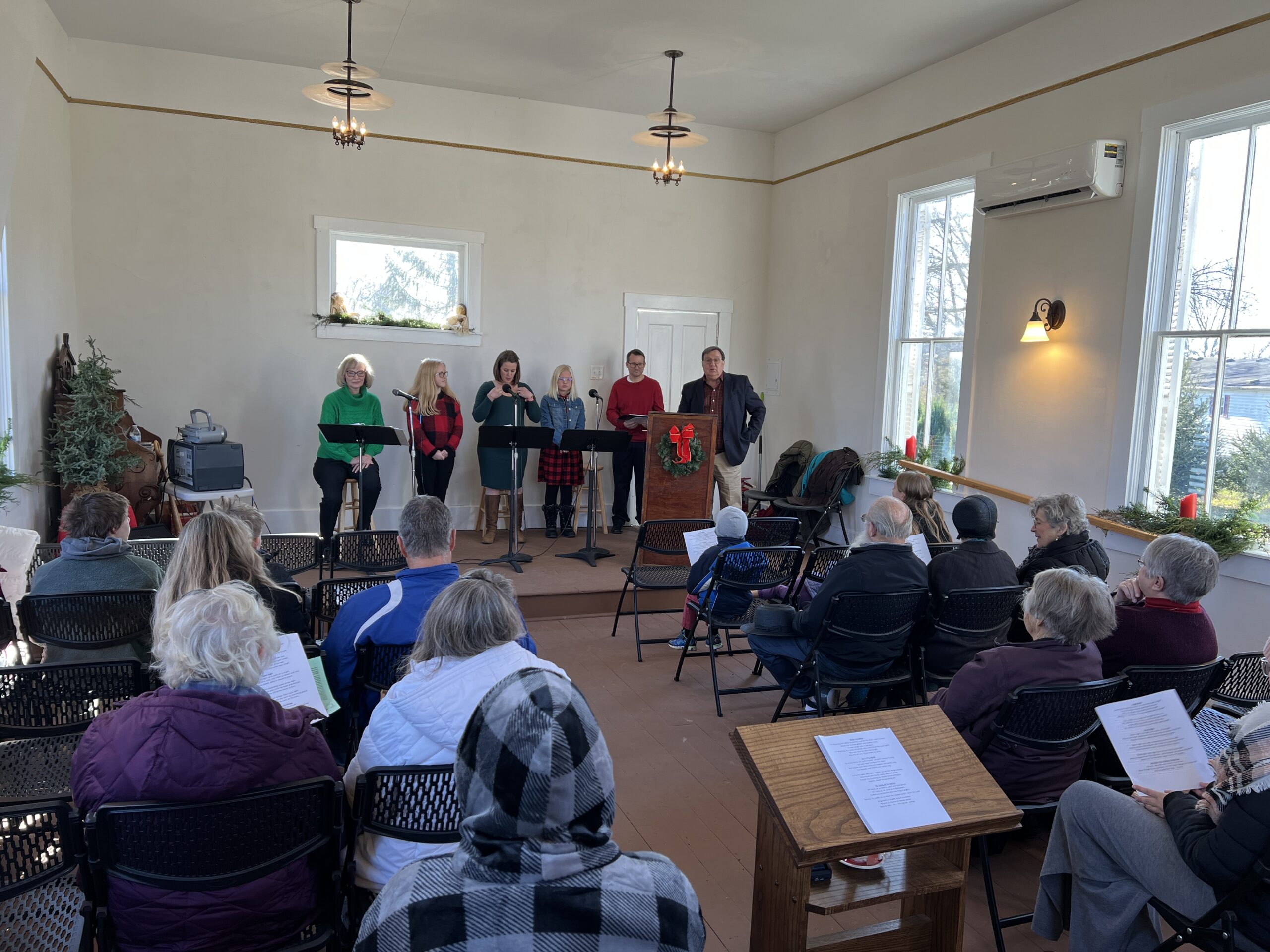 A group participates in a singalong inside the White Chapel